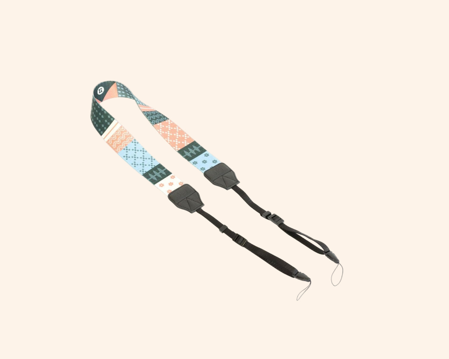 Adjustable strap for portable backgammon board with colorful geometric pattern in teal, peach and white