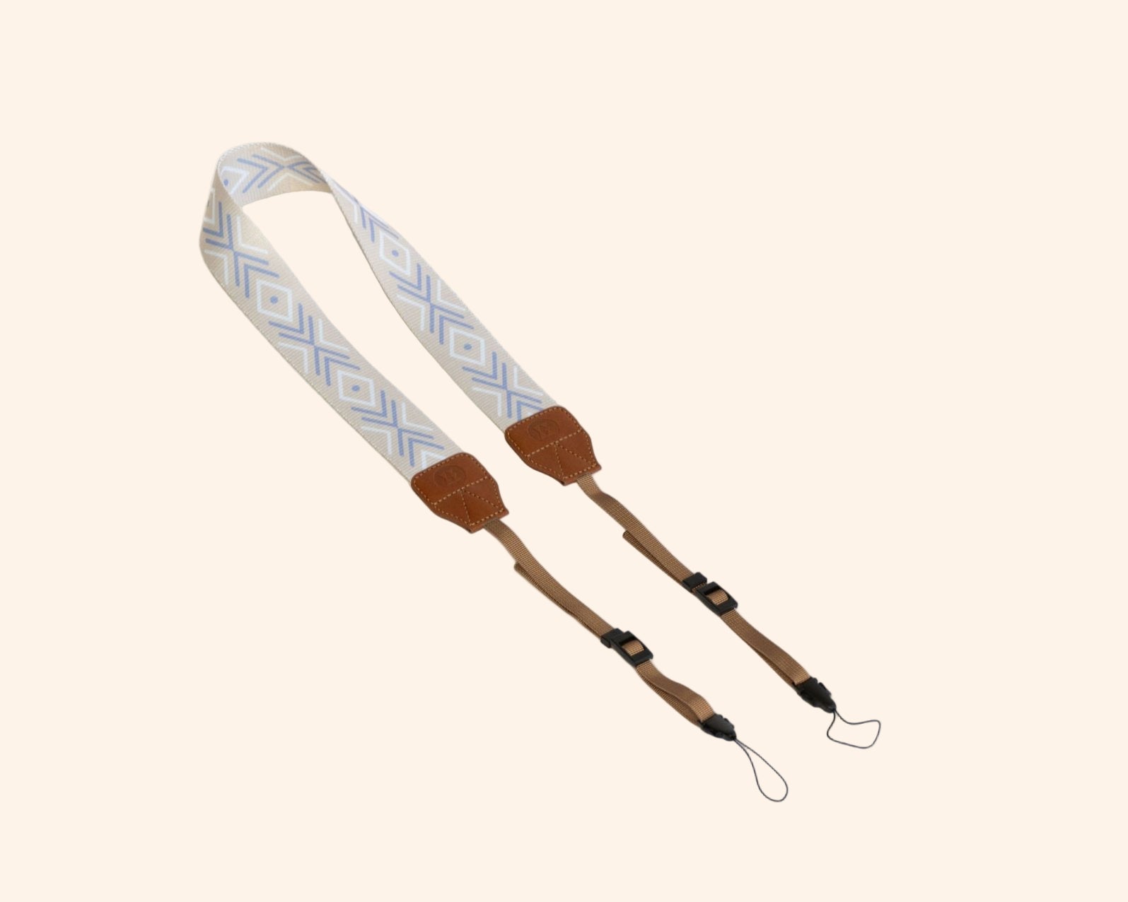 Light blue and beige geometric pattern strap for portable backgammon board with brown leather ends and rope attachments