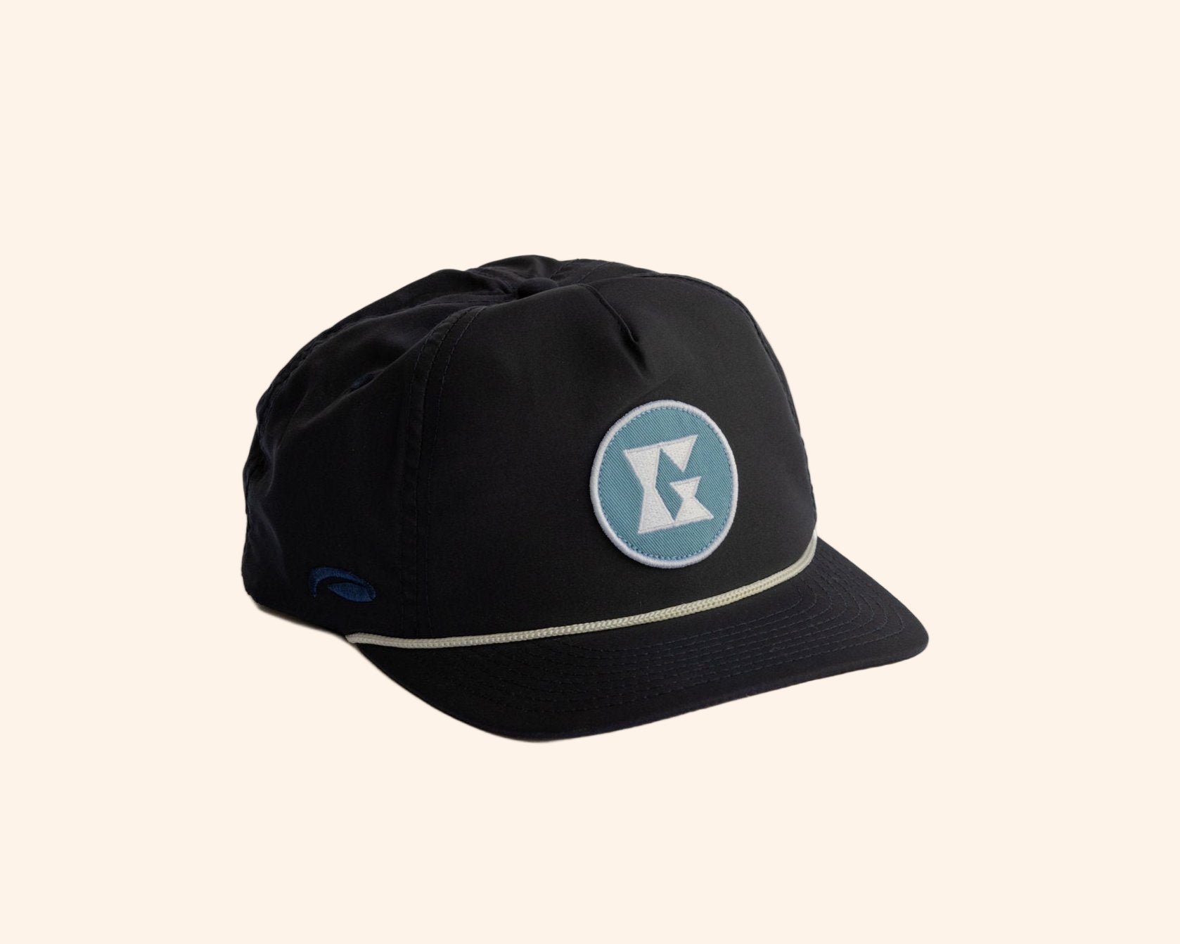 Black 5-panel hat with Gammn logo patch and light trim, angled on white background